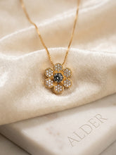 Midnight Sapphire Sunburst Necklace on cream fabric