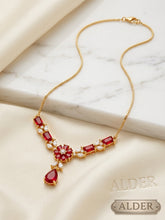 Royal Sapphire Halo Pendant Necklace on cream fabric