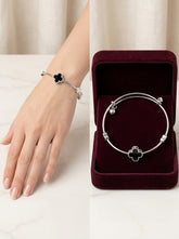 Alder Noir Clover Silver Bangle on wrist and in burgundy Alder gift box